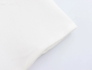 Detailed macro view of white corduroy fabric texture and sleeve cuff of the retro dress