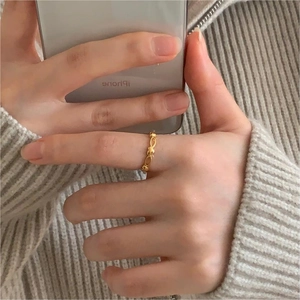 Detailed view of an 18K gold-plated heart-shaped open ring worn on a finger