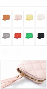 Close-up of quilted card holder with gold zippers and wristlets in multiple colors