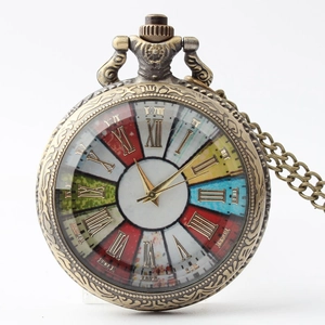 Close-up of vintage bronze pocket watch with colorful Roman numeral dial and ornate engraving