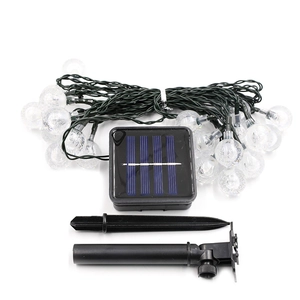 Solar powered string lights with clear bubble globes for outdoor festive garden ambiance