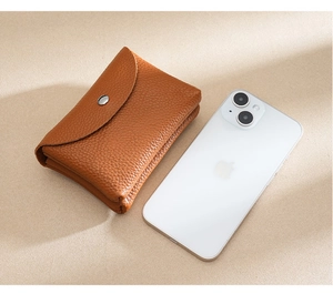 Detailed macro view of brown lychee grain genuine leather coin purse with silver snap