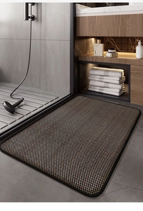 Detail of rectangular bathroom mat with brown black woven texture and waterproof edges