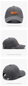Detail view of gray plaid quick-dry baseball cap with orange S embroidery and metal buckle