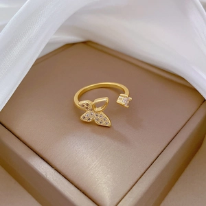 Detailed macro shot of gold butterfly open ring with sparkling pavé crystals and square gem