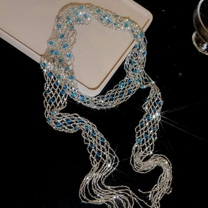 Sparkling silver beaded mesh scarf necklace with blue crystal accents and long fringes.