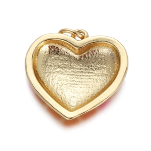 Macro shot of the frosted gold metal back of an orange gradient heart pendant jewelry