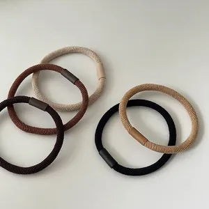 Five elastic hair ties in brown earth tones on white background for high ponytail styles