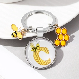 Cute bee and honeycomb keychain with letter C enamel charm and a pearl accent