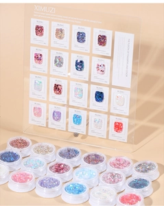 Macro display of 18 glitter nail art colors with holographic flakes in clear round pots