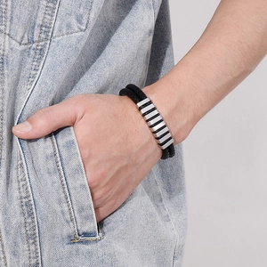 Men's double-layered braided leather bracelet with silver magnetic steel clasp on wrist