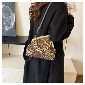 Detail of retro leopard print shell bag with chunky gold chain and leather shoulder strap