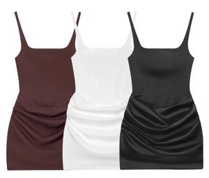 Detail of sexy sleeveless bodycon dresses in red, white, and black with ruched satin fabric