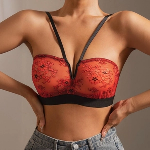 Close-up of red floral lace bralette with black straps and elastic band detail