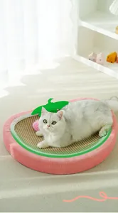 Detail view of pink strawberry cat scratcher bed with sisal pad and cat resting inside