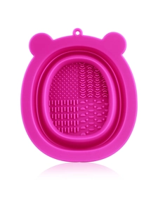 Detailed view of pink silicone makeup brush cleaner mat with multiple scrubbing textures