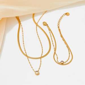 Double-layered gold snake chain bracelet and necklace set with round zircon charms