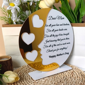 Detail of round Mother's Day acrylic plaque with gold hearts and floral background