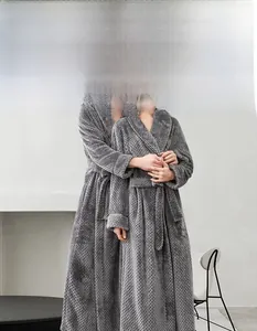 Detailed texture of charcoal grey pineapple grid flannel fabric on long winter bathrobe