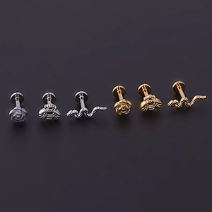 Detail of rose, bee, and snake labret studs in silver and gold polished finishes