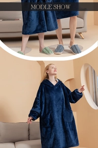 Detail view of navy blue oversized hoodie blanket with large pockets and rib cuffs