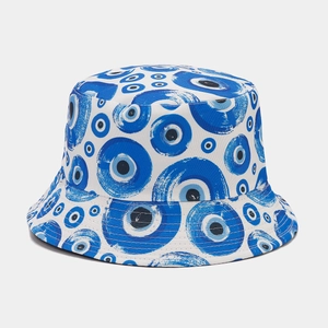 Detailed view of the Evil Eye print texture on a white reversible bucket hat fabric