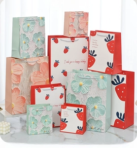 Detail of assorted floral and strawberry gift bags with durable woven handles