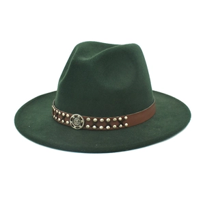 Detail of dark green wool fedora hat with brown studded leather band and metal badge