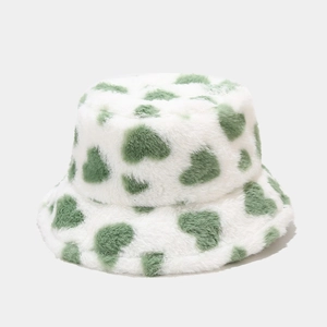 Detailed view of the soft plush texture and green heart pattern on a white bucket hat
