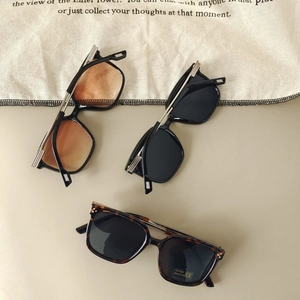 Close-up of children's UV400 sunglasses in black, tea, and tortoise frame finishes