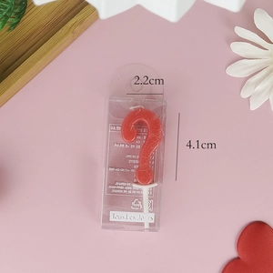 Detailed view of a red question mark birthday candle with size measurements 2.2cm x 4.1cm