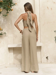 Chic backless halter top and wide-leg trousers set in olive green linen texture