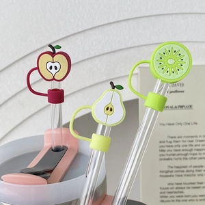 Macro detail of three fruit-shaped straw covers featuring apple, pear and kiwi designs