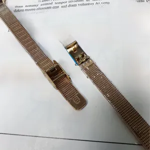 Detail of rose gold Milanese mesh watch strap with adjustable magnetic buckle