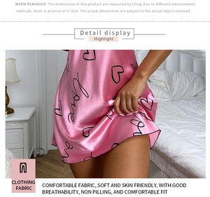 Close-up of pink silk sleepwear featuring heart prints and soft texture detail