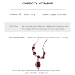 Detailed view of red oval zircon pendant with white stones and size specifications
