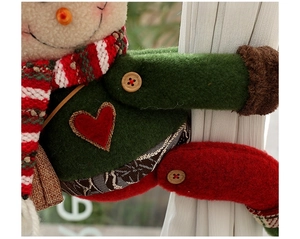 Detail of Christmas snowman curtain buckle with button closure and flexible limbs