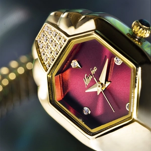 Macro detail of gold snake-shaped watch with burgundy dial and diamond markers