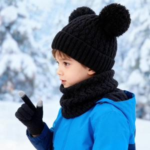 Winter kids knit set featuring double pom-pom beanie, scarf, and gloves in snowy setting