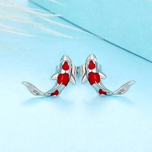 Detailed view of koi fish earrings featuring red enamel and sparkling zircon accents
