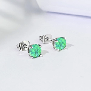 Detail of 6mm green opal stud earrings featuring a 4-claw gold plated setting