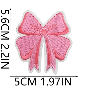 Pink embroidered bow patch showing detailed dimensions in centimeters and inches