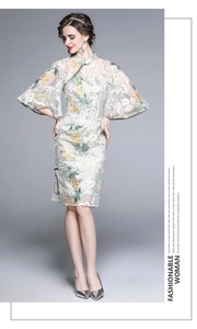 Exquisite floral embroidery and traditional button details on a white lace qipao dress