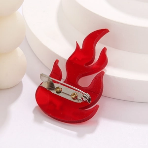 Close-up of the back metal pin attachment on a red acrylic flame brooch