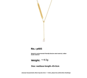 Detail of leaf charm and resin pearl pendant on 18k gold-plated titanium steel necklace