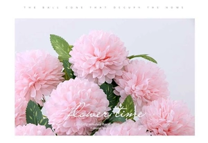 Detailed macro view of pink artificial dandelion flower with green textured leaves