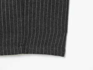 Close-up of charcoal gray pinstripe fabric showing high-quality texture and stitching