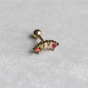 Close-up of golden curved barbell stud with five colorful rectangular gemstones
