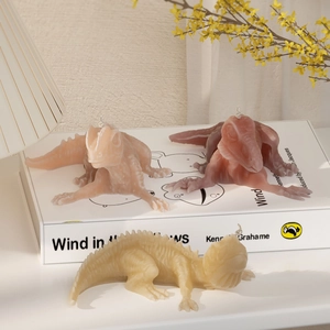 Detailed view of colorful 3D dinosaur candles with intricate skin textures on a desk