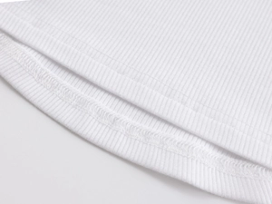 Macro shot of fine ribbed knit fabric and reinforced double stitching on white tank top